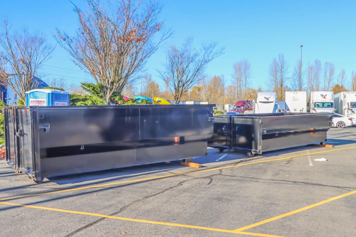 Professional dumpster rental service with roll-off container on residential driveway in Clarksdale